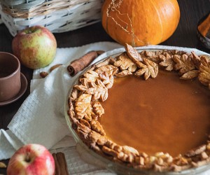 Photo of Pumpkin Pie with fall spices, apples, and pumpkins